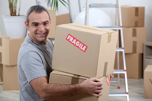 Removal team planning a local move in Merton with boxes and furniture