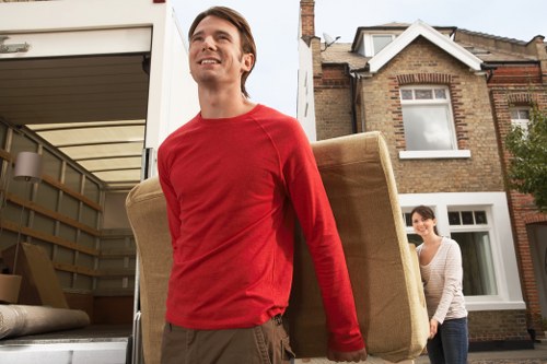 Local removal team handling furniture during a Merton house move