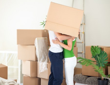 Boxes and furniture being moved from a flat in Merton