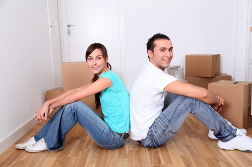 Local office removals team handling furniture in a commercial space in Merton