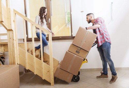 Moving team handling furniture and boxes in Merton