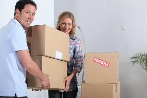 Packed moving boxes and furniture ready for truck hire in Merton