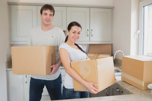 Packed moving boxes and furniture ready for removal in Merton